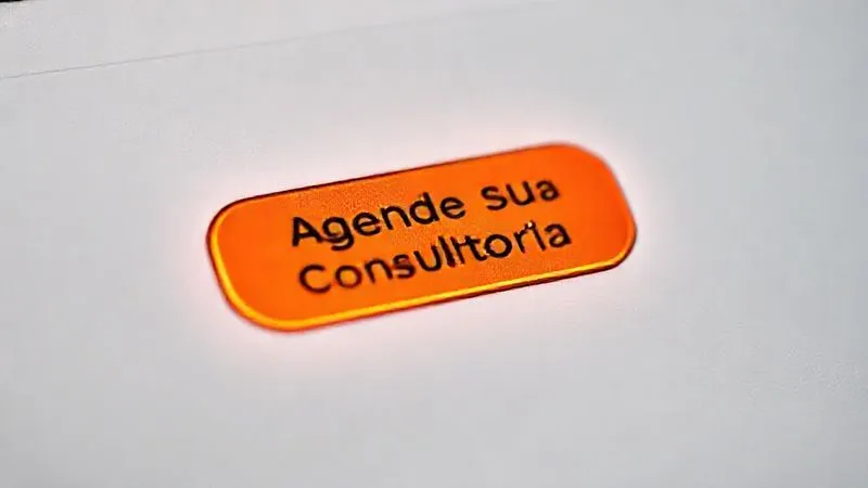 A photorealistic close-up of a vibrant, orange call-to-action button on a clean, minimalist webpage design. The button reads 'Agende Sua Consultoria Gratuita' with a subtle glow. Surrounding text emphasizes benefits in bullet points. Cinematic lighting, sharp focus on the button, depth of field blurring the background elements of the webpage, 8K hyper-detailed, professional photography.