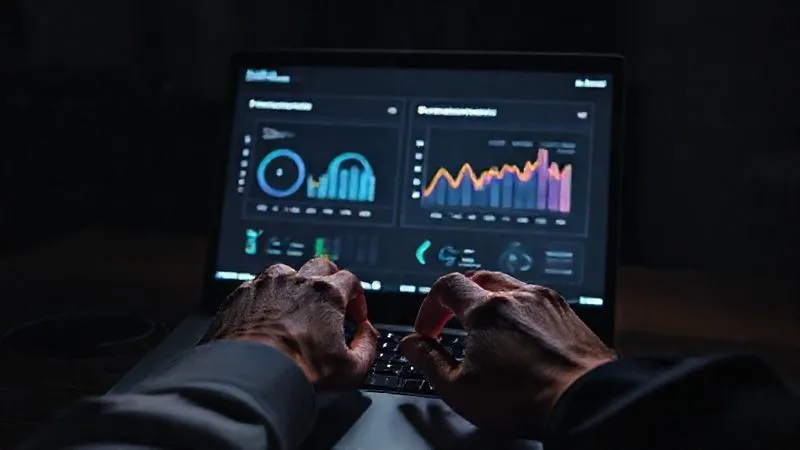 A photorealistic image of a freelancer's hands on a laptop keyboard, with a split screen showing two dashboards: one labeled 'Before Automation' with lower numbers and another labeled 'After Automation' with significantly higher, positive metrics. The screen glows softly in a dim room, conveying focus and analysis. Cinematic lighting, sharp focus on the hands and screen, depth of field. 8K hyper-detailed.