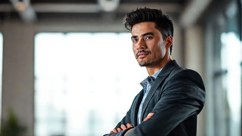 A photorealistic image of a confident, poised person, possibly a freelancer, standing tall in a professional setting, with a subtle glow of determination around them. Their body language exudes self-assurance and readiness for new challenges. Cinematic lighting, sharp focus on the individual, depth of field blurring the background, 8K hyper-detailed, shot on a high-end DSLR.