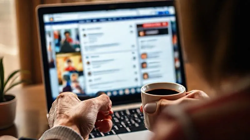 A photorealistic image of a vibrant online community forum interface on a laptop screen, with diverse user avatars and active discussions. In the foreground, a hand holds a coffee cup, suggesting continuous engagement. Cinematic lighting, sharp focus on the community interaction, depth of field. 8K hyper-detailed, professional photography, shot on a high-end DSLR.